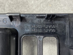 Close-up of a black plastic automotive component with embossed part numbers 74231-52750 and 74231-52790, showing small tabs and ridges.