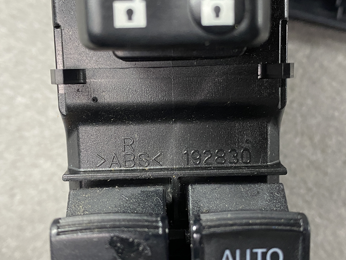14021815_pw_switch_9 TOYOTA Genuine Master Power Window Switch AQUA NHP10 / 192830 / 74231-52750 / 74231-52790 » NZ4.95 » JDM-PARTS NZ » JDM-PARTS NZ Close-up of a black car switch with an 'AUTO' button; the housing is stamped with 'R ABS 192830'. TOYOTA Genuine Master Power Window Switch AQUA NHP10 / 192830 / 74231-52750 / 74231-52790 » JDM-PARTS NZ