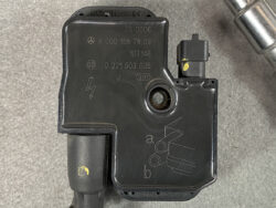 Mercedes-Benz Bosch ABS/ESP control module with wiring harness and mounting hole (part numbers visible)