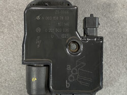 Bosch automotive ABS control module with electrical connector and mounting hole on a gray concrete surface