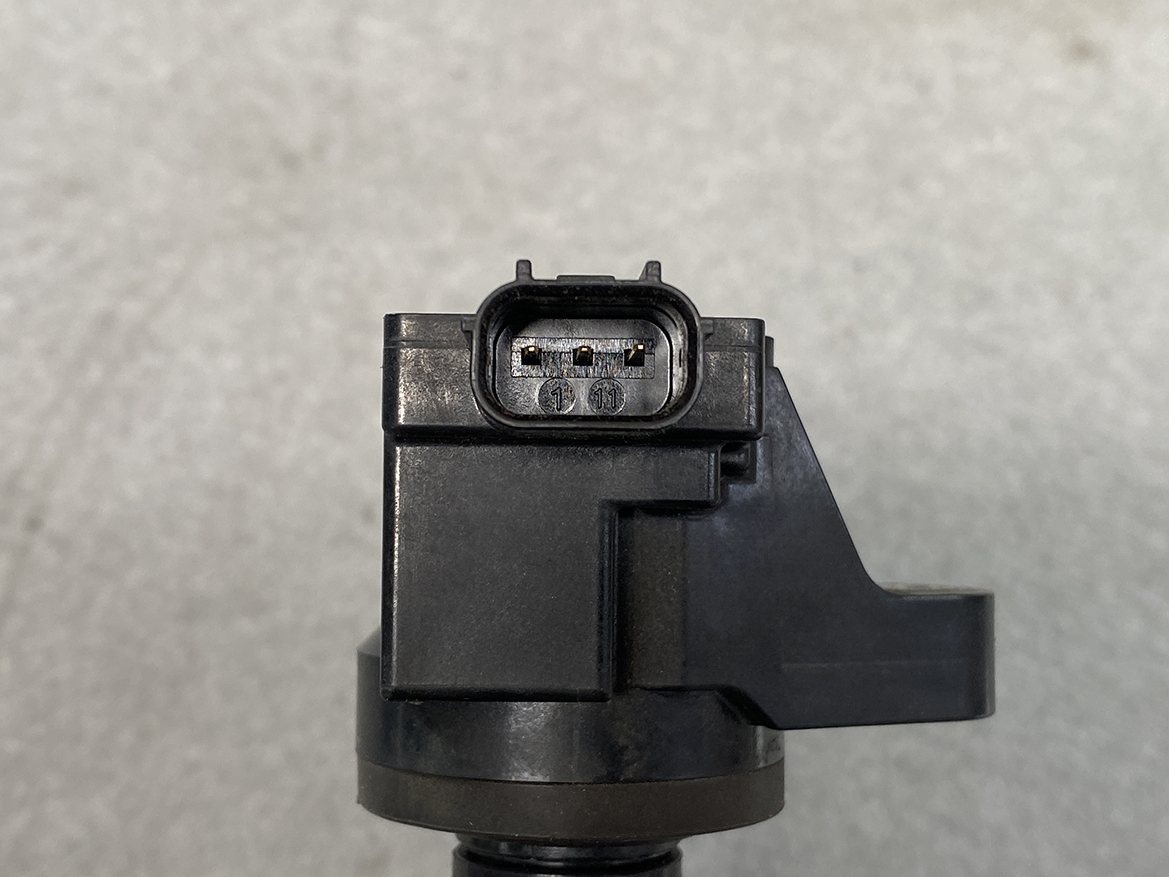 HON-COIL-CM11-116_3 HONDA Genuine IGNITION COIL CM11-116 / L-series Engine » NZ.95 » JDM-PARTS NZ » JDM-PARTS NZ Close-up of a black plastic electrical connector with four metal pins on a device component HONDA Genuine IGNITION COIL CM11-116 / L-series Engine » JDM-PARTS NZ