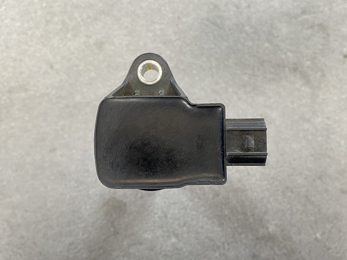 HON-COIL-CM11-116_6 HONDA Genuine IGNITION COIL CM11-116 / L-series Engine » NZ.95 » JDM-PARTS NZ » JDM-PARTS NZ Black automotive sensor with a mounting tab and side electrical connector, used for engine/vehicle systems. HONDA Genuine IGNITION COIL CM11-116 / L-series Engine » JDM-PARTS NZ