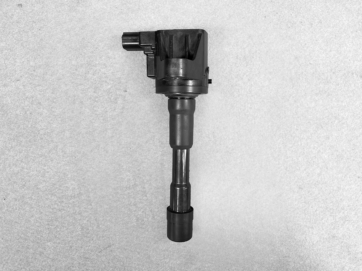 HON-COIL-CM11-118_1 HONDA Genuine IGNITION COIL CM11-118 / L-series Engine » NZ.95 » JDM-PARTS NZ » JDM-PARTS NZ Automotive ignition coil with spark plug boot mounted on a gray background (vertical orientation). HONDA Genuine IGNITION COIL CM11-118 / L-series Engine » JDM-PARTS NZ