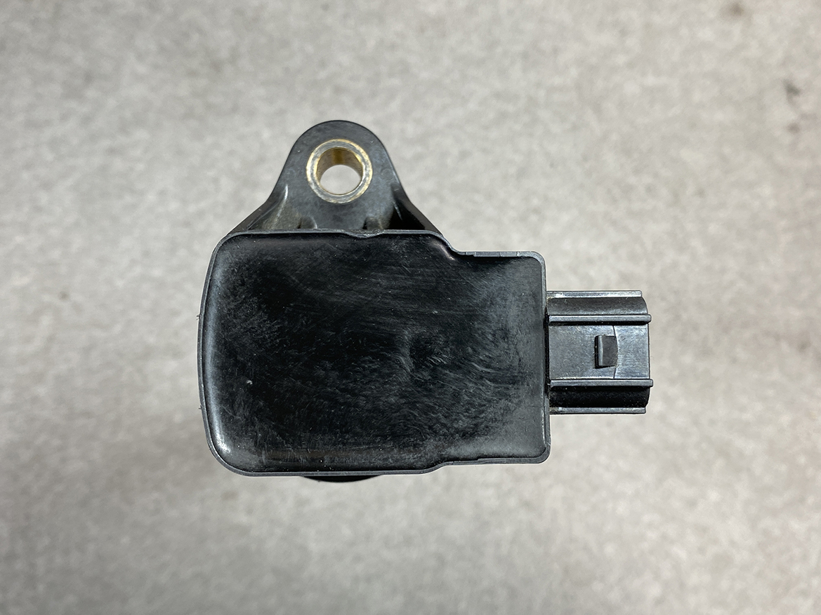 HON-COIL-CM11-118_6 HONDA Genuine IGNITION COIL CM11-118 / L-series Engine » NZ.95 » JDM-PARTS NZ » JDM-PARTS NZ Black automotive sensor housing with a mounting tab and a right-side electrical connector. HONDA Genuine IGNITION COIL CM11-118 / L-series Engine » JDM-PARTS NZ