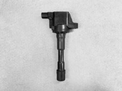 Automotive ignition coil with spark plug boot on a gray background