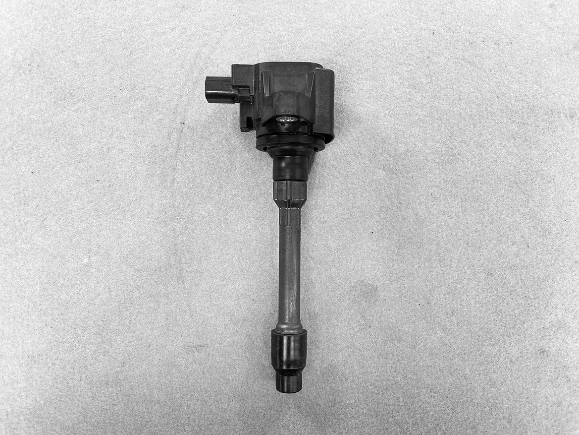 HON-COIL-CM11-121A_1 HONDA Genuine IGNITION COIL CM11-121A / L-series Engine » NZ.95 » JDM-PARTS NZ » JDM-PARTS NZ Automotive ignition coil with electrical connector and spark plug boot on a gray background. HONDA Genuine IGNITION COIL CM11-121A / L-series Engine » JDM-PARTS NZ