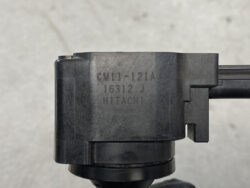 Close-up of a black Hitachi CM11-12IA component with stamped model numbers on a plastic housing.