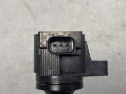 Close-up of a three-pin rectangular electrical connector embedded in a black plastic device.