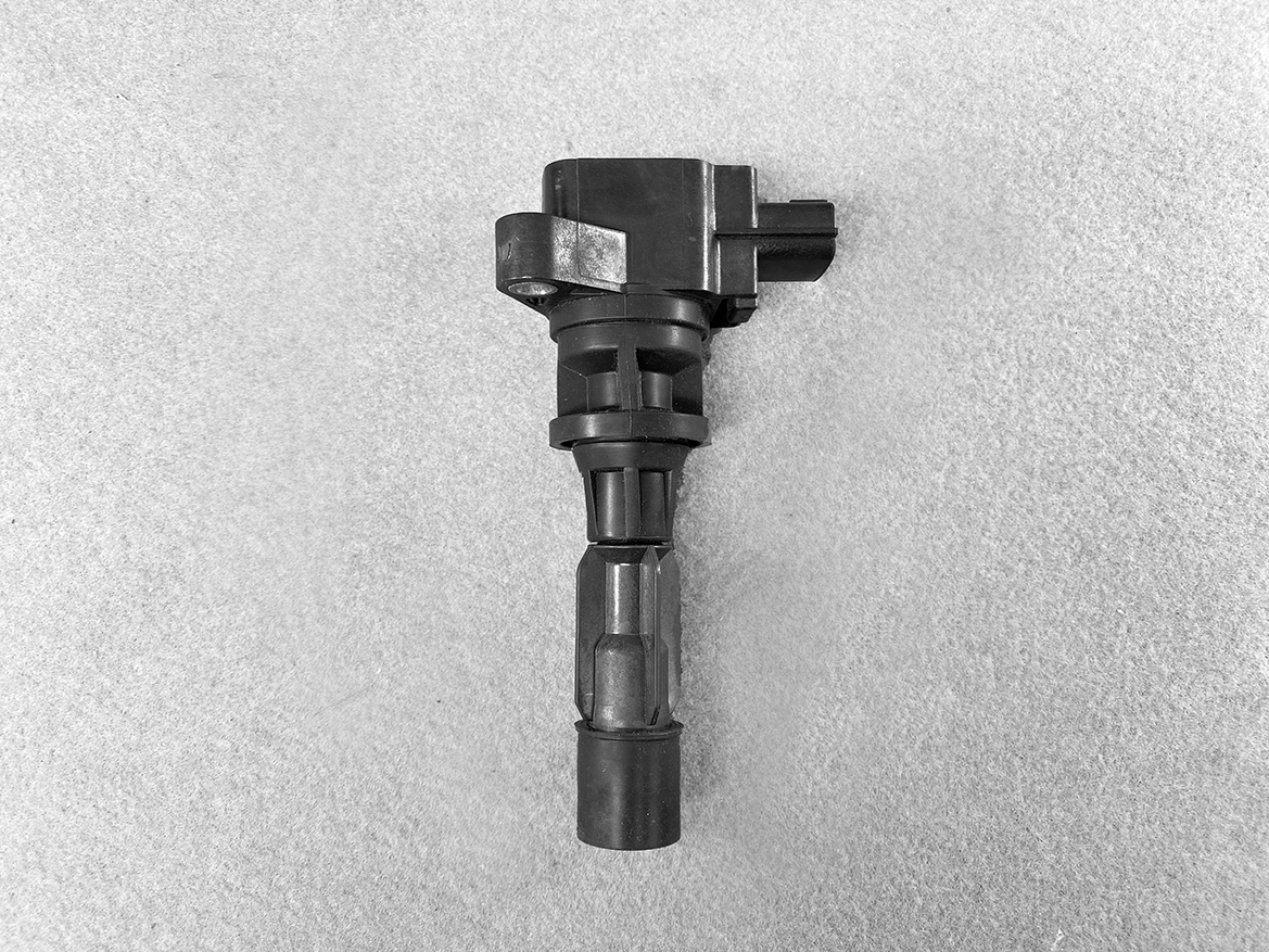 MAZ-COIL-LF2L_1 MAZDA Genuine IGNITION COIL K4238 / LF2L-18-100 / LF, L3 Engine » NZ.95 » JDM-PARTS NZ » JDM-PARTS NZ Automotive ignition coil with a connector on a gray surface MAZDA Genuine IGNITION COIL K4238 / LF2L-18-100 / LF, L3 Engine » JDM-PARTS NZ