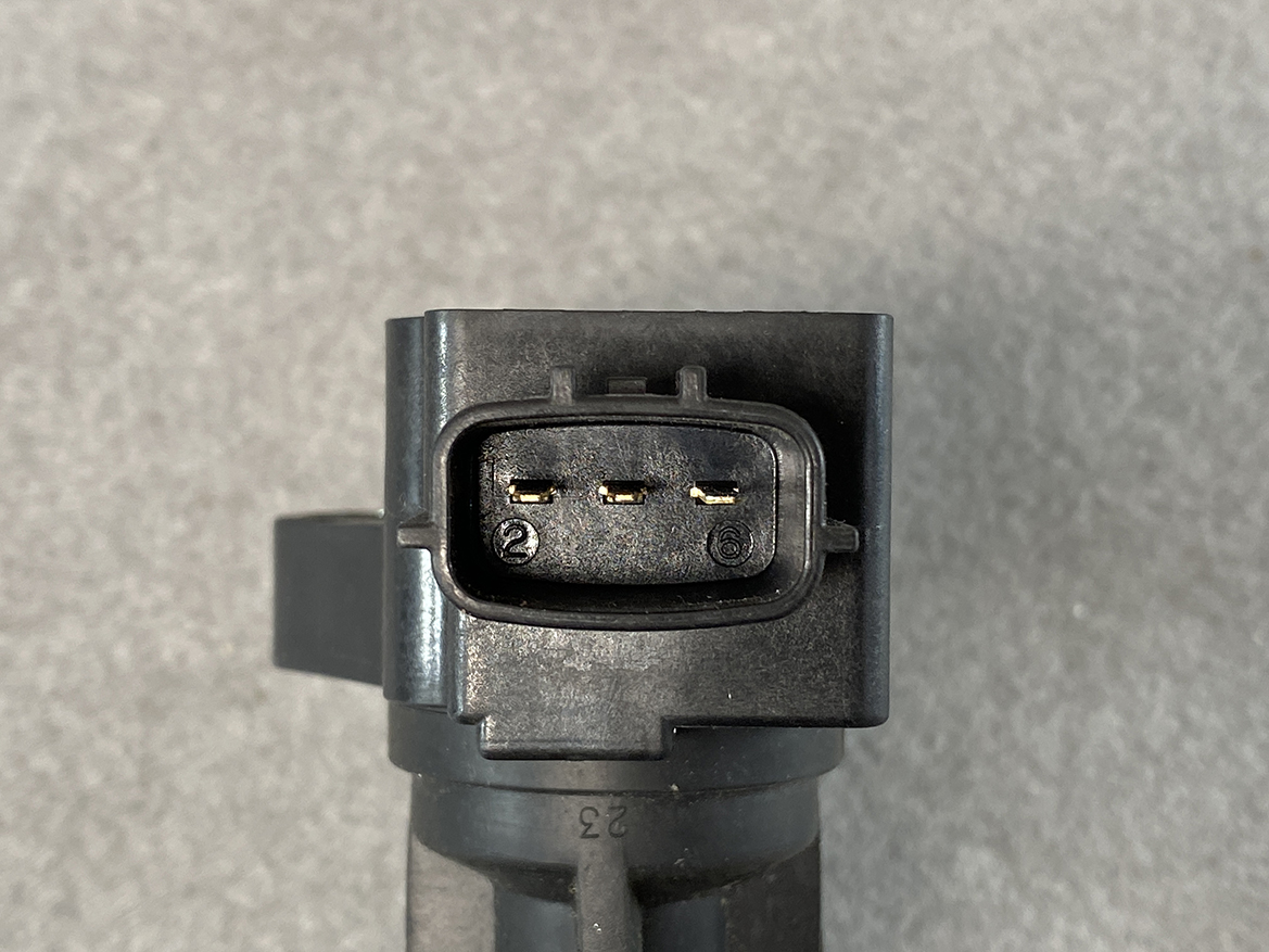 MAZ-COIL-LF2L_3 MAZDA Genuine IGNITION COIL K4238 / LF2L-18-100 / LF, L3 Engine » NZ.95 » JDM-PARTS NZ » JDM-PARTS NZ Three-pin black automotive connector with gold pins inside an oval housing, viewed head-on on a gray surface. MAZDA Genuine IGNITION COIL K4238 / LF2L-18-100 / LF, L3 Engine » JDM-PARTS NZ
