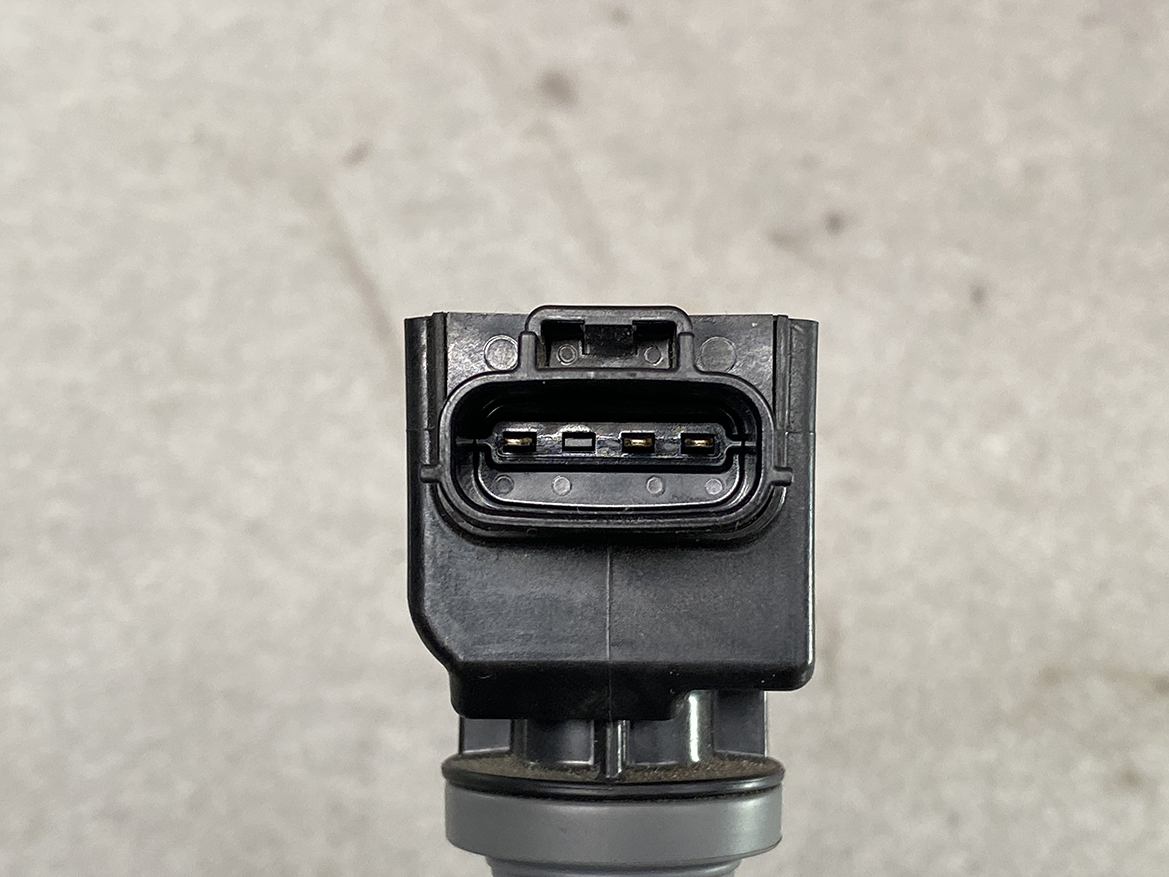 MAZ-COIL-P51R18100_3 MAZDA Genuine IGNITION COIL H6T15571 / P51R-18-100 SKYACTIV-G » NZ.95 » JDM-PARTS NZ » JDM-PARTS NZ Close-up of a weather-sealed automotive multi-pin connector with five visible gold contacts inside a black plastic housing on a sensor mount. MAZDA Genuine IGNITION COIL H6T15571 / P51R-18-100 SKYACTIV-G » JDM-PARTS NZ