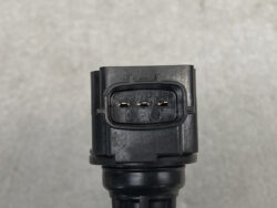 Close-up of a black four-pin electrical connector on a vehicle harness, showing metal contacts in a rectangular housing labeled 1 to 4.