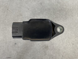 Automotive sensor with a left-side electrical connector and a mounting lug on the right.