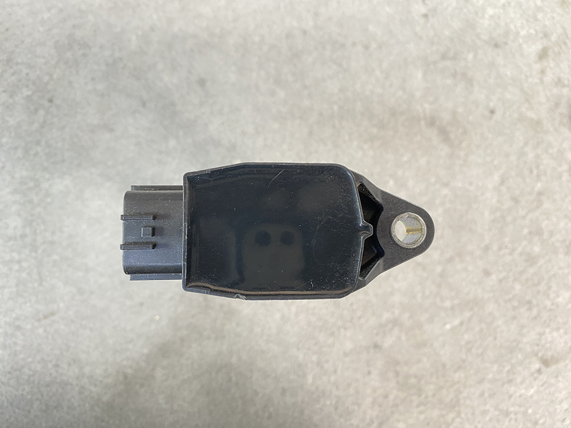 NIS-COIL-1KT0A_6 NISSAN Genuine Ignition Coil 22448 1KT0A / HR, MR, QR Engine » NZ.95 » JDM-PARTS NZ » JDM-PARTS NZ Black automotive sensor with rectangular body, plug on the left, and a mounting tab with a hole on the right. NISSAN Genuine Ignition Coil 22448 1KT0A / HR, MR, QR Engine » JDM-PARTS NZ