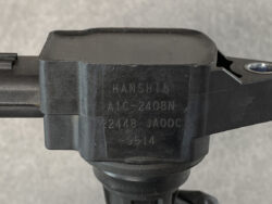 Close-up of a black mounting component labeled HANSHIN ANC-2408N with serial numbers etched on the side