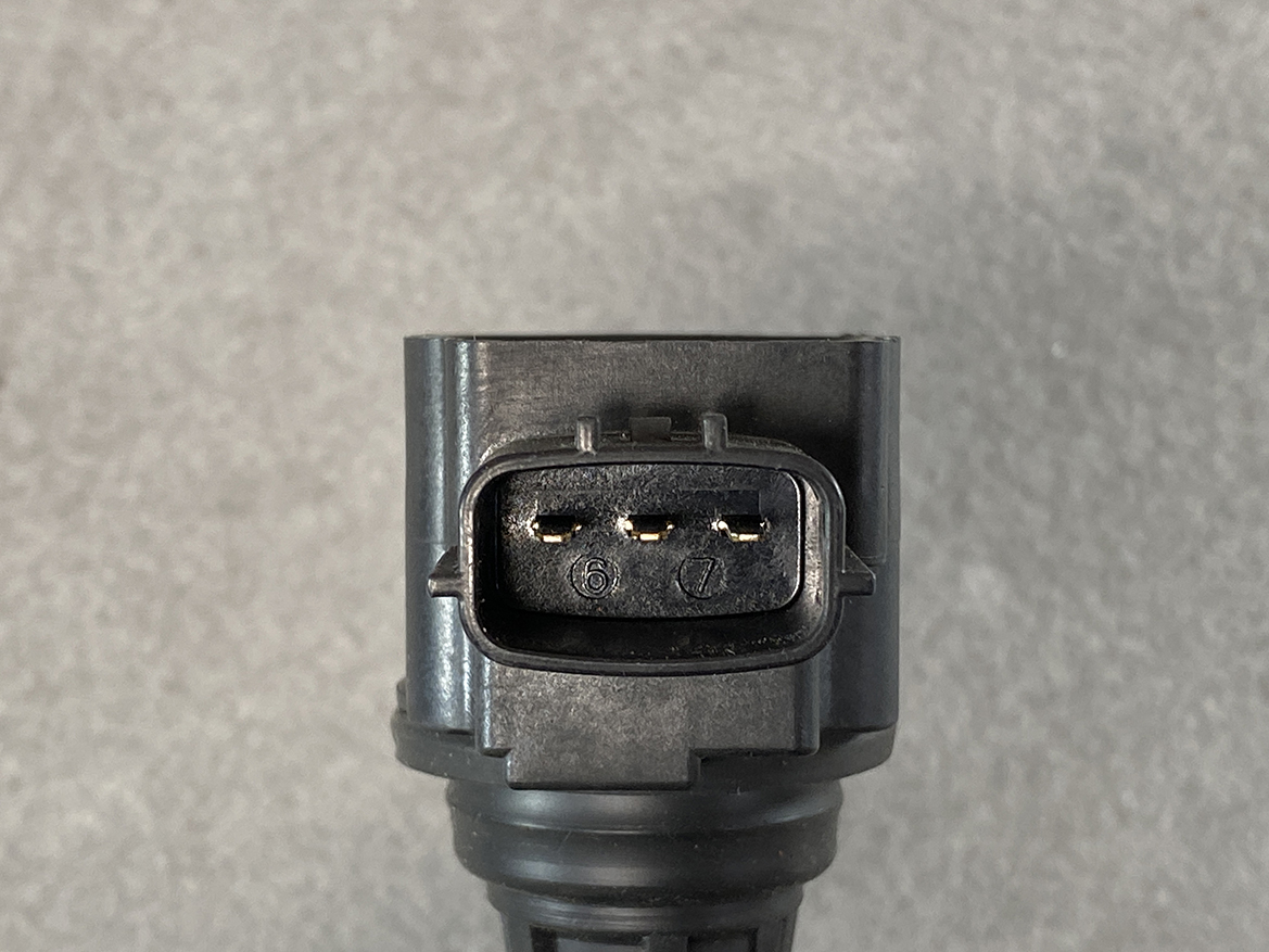 NIS-COIL-JA00C_3 NISSAN Genuine IGNITION COIL 22448 JA00C / MR QR Engine » NZ.95 » JDM-PARTS NZ » JDM-PARTS NZ Close-up of a black automotive 3-pin connector with two visible metal contacts and numbering 6 and 7 on the receptacle edge, mounted to a gray housing — the connector's front view for wiring. NISSAN Genuine IGNITION COIL 22448 JA00C / MR QR Engine » JDM-PARTS NZ