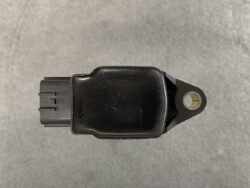 Black automotive sensor module with a two-pin connector on the left and a mounting tab with a bolt hole on the right.