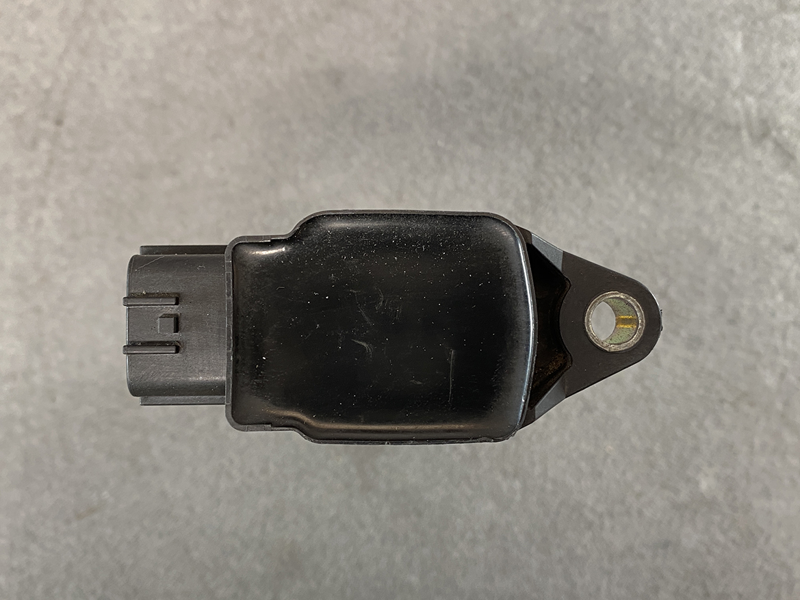 NIS-COIL-JA00C_6 NISSAN Genuine IGNITION COIL 22448 JA00C / MR QR Engine » NZ.95 » JDM-PARTS NZ » JDM-PARTS NZ Black automotive sensor module with a two-pin connector on the left and a mounting tab with a bolt hole on the right. NISSAN Genuine IGNITION COIL 22448 JA00C / MR QR Engine » JDM-PARTS NZ