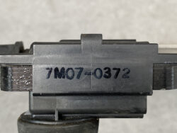 Close-up of a firearm component with the serial number 7M07-0372 engraved on it.