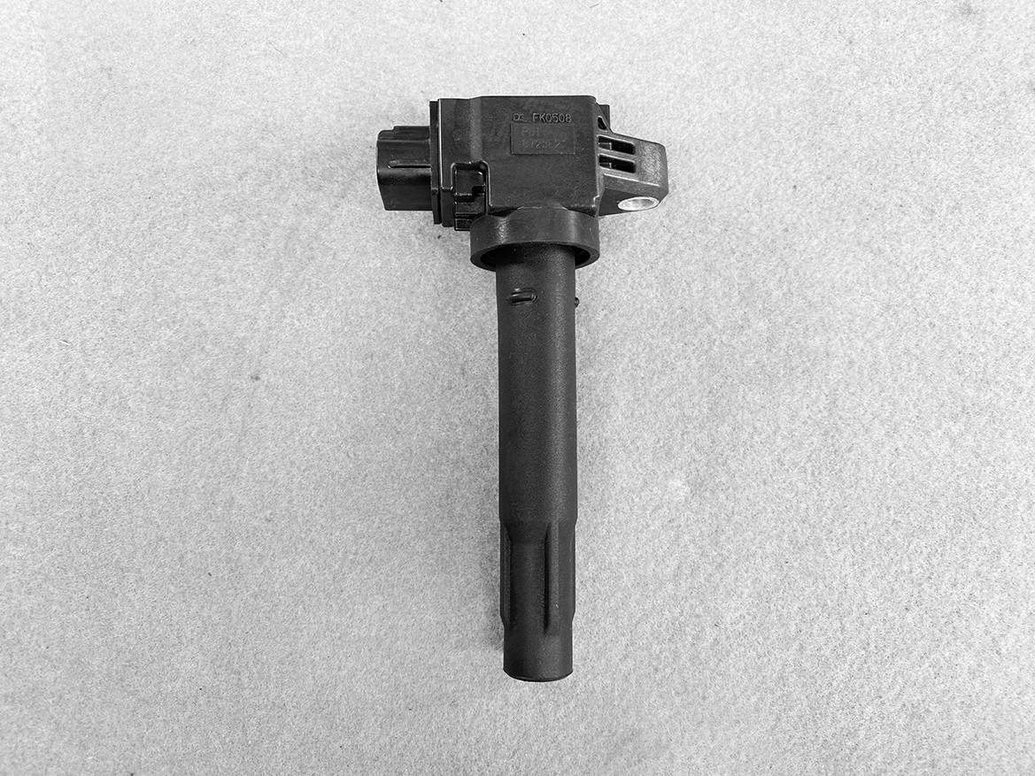 SUZ-COIL-FK0508_1 SUZUKI Genuine IGNITION COIL FK0508 / R06A, K12B Engine » NZ.95 » JDM-PARTS NZ » JDM-PARTS NZ Automotive ignition coil with electrical connector, shown on a gray background, part of the ignition system. SUZUKI Genuine IGNITION COIL FK0508 / R06A, K12B Engine » JDM-PARTS NZ