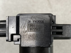 Close-up of a black plastic connector housing with engraved part numbers FK0508 and PD1 8725E2 on the surface