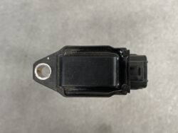 Top view of a black rectangular automotive sensor with a mounting hole on the left and a right-side electrical connector.