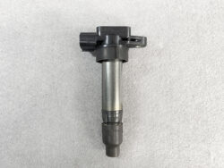 Automotive ignition coil with electrical connector and spark plug boot in a vertical orientation