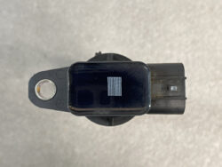 Black rectangular sensor module mounted on a circular base, with a metal mounting hole on the left and a small grid of contacts on top viewed from above.