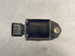 Small black electronic sensor module with a left-side plug connector and a right-side mounting boss; compact automotive sensor housing.