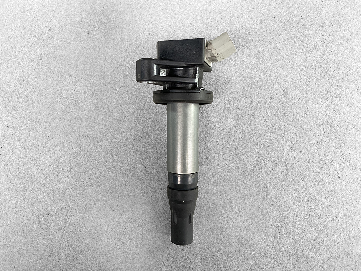 TOY-COIL-B2050_1 TOYOTA / DAIHATSU Genuine IGNITION COIL / 19500-B2050 / KF Engine » NZ.95 » JDM-PARTS NZ » JDM-PARTS NZ Automotive ignition coil with a rubber spark plug boot and electrical connector on a gray surface. TOYOTA / DAIHATSU Genuine IGNITION COIL / 19500-B2050 / KF Engine » JDM-PARTS NZ