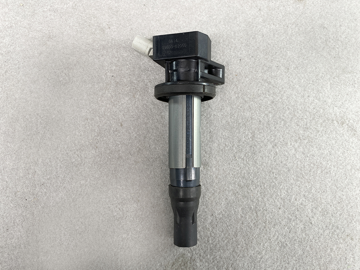 TOY-COIL-B2050_4 TOYOTA / DAIHATSU Genuine IGNITION COIL / 19500-B2050 / KF Engine » NZ.95 » JDM-PARTS NZ » JDM-PARTS NZ Automotive ignition coil with a rubber boot, placed on a gray concrete surface TOYOTA / DAIHATSU Genuine IGNITION COIL / 19500-B2050 / KF Engine » JDM-PARTS NZ