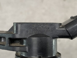 Close-up of a Denso automotive part with the stamped text 'DENSO MADE IN JAPAN 099700-1070'.