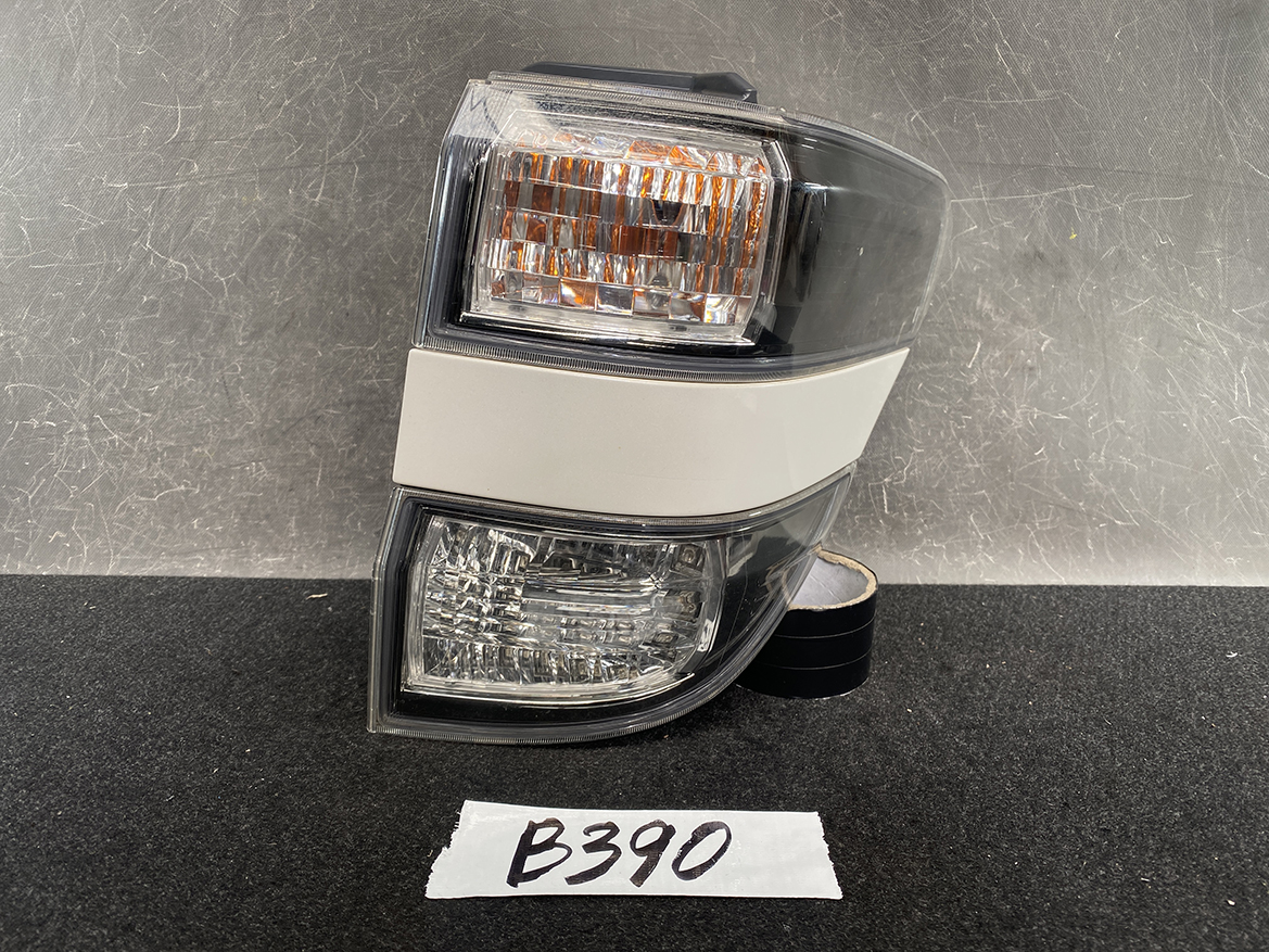 B390_1 TOYOTA ALPHARD VELLFIRE ANH20 Genuine Taillight KOITO 58-29 Right Side x1 » NZ1.95 » JDM-PARTS NZ » JDM-PARTS NZ Tail light assembly for a vehicle featuring amber turn signal and clear reverse lights, shown on a dark surface. TOYOTA ALPHARD VELLFIRE ANH20 Genuine Taillight KOITO 58-29 Right Side x1 » JDM-PARTS NZ