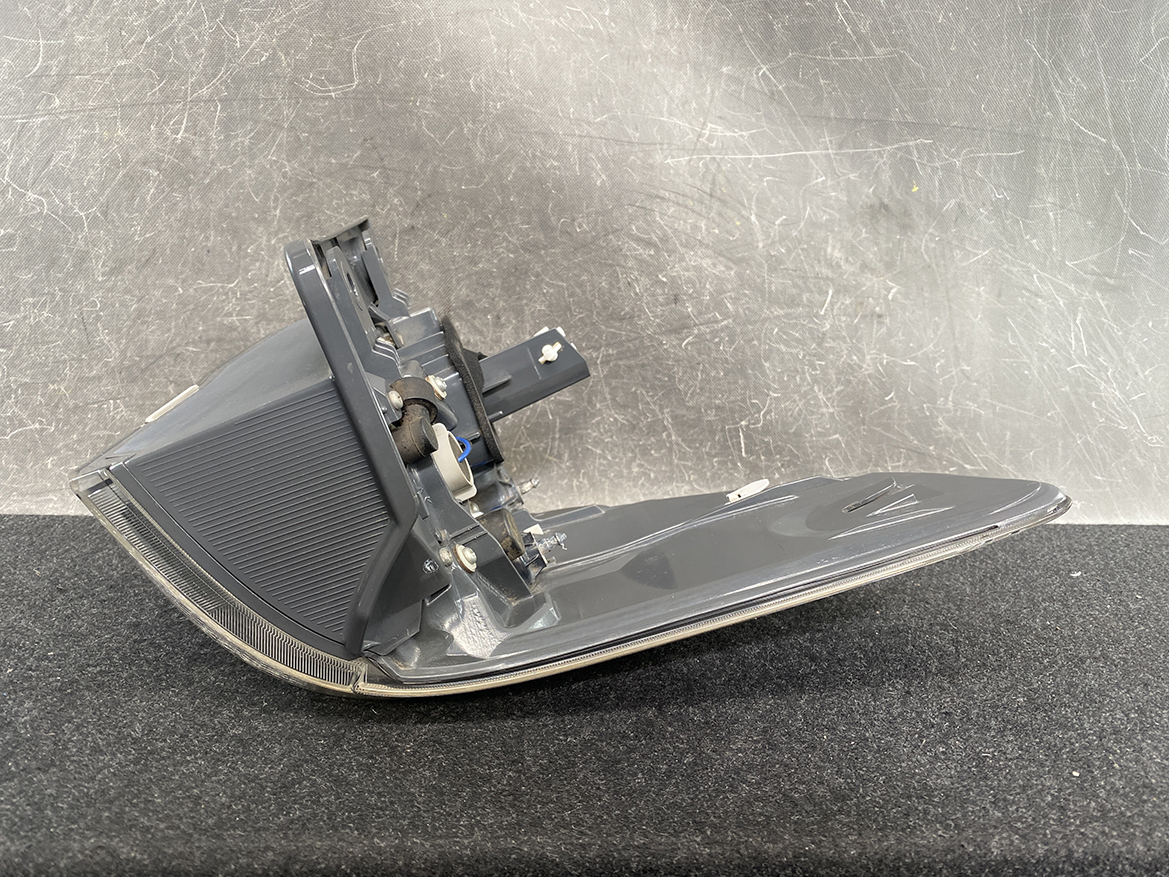 B390_5 TOYOTA ALPHARD VELLFIRE ANH20 Genuine Taillight KOITO 58-29 Right Side x1 » NZ1.95 » JDM-PARTS NZ » JDM-PARTS NZ Detached gray car tail light housing with mounting bracket and wiring, resting on a dark surface TOYOTA ALPHARD VELLFIRE ANH20 Genuine Taillight KOITO 58-29 Right Side x1 » JDM-PARTS NZ