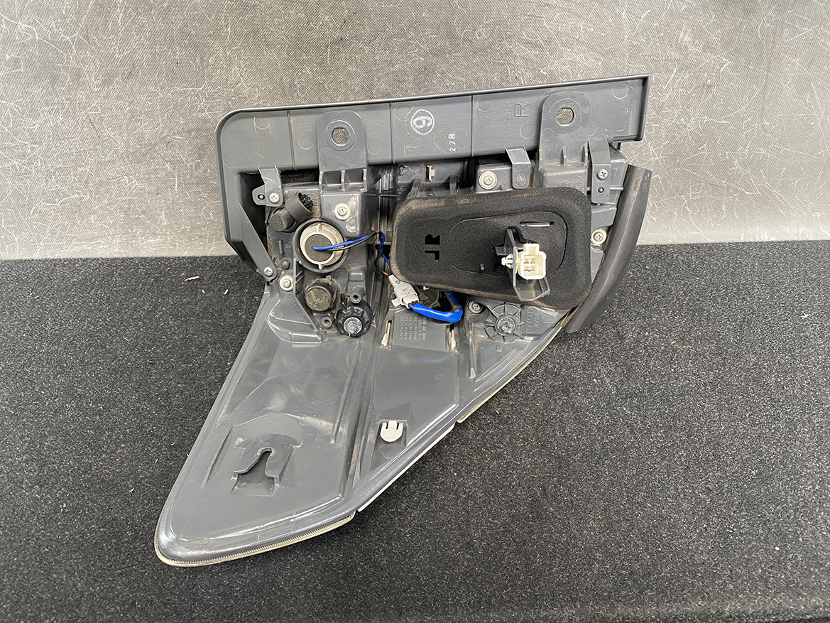 B390_7 TOYOTA ALPHARD VELLFIRE ANH20 Genuine Taillight KOITO 58-29 Right Side x1 » NZ1.95 » JDM-PARTS NZ » JDM-PARTS NZ Rear car tail light assembly with the cover removed, showing bulbs, wiring, and connectors inside the gray plastic housing TOYOTA ALPHARD VELLFIRE ANH20 Genuine Taillight KOITO 58-29 Right Side x1 » JDM-PARTS NZ