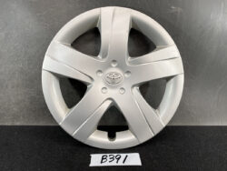 Silver Toyota wheel cover (hubcap) with five-spoke design and centered logo, shown against a dark background.