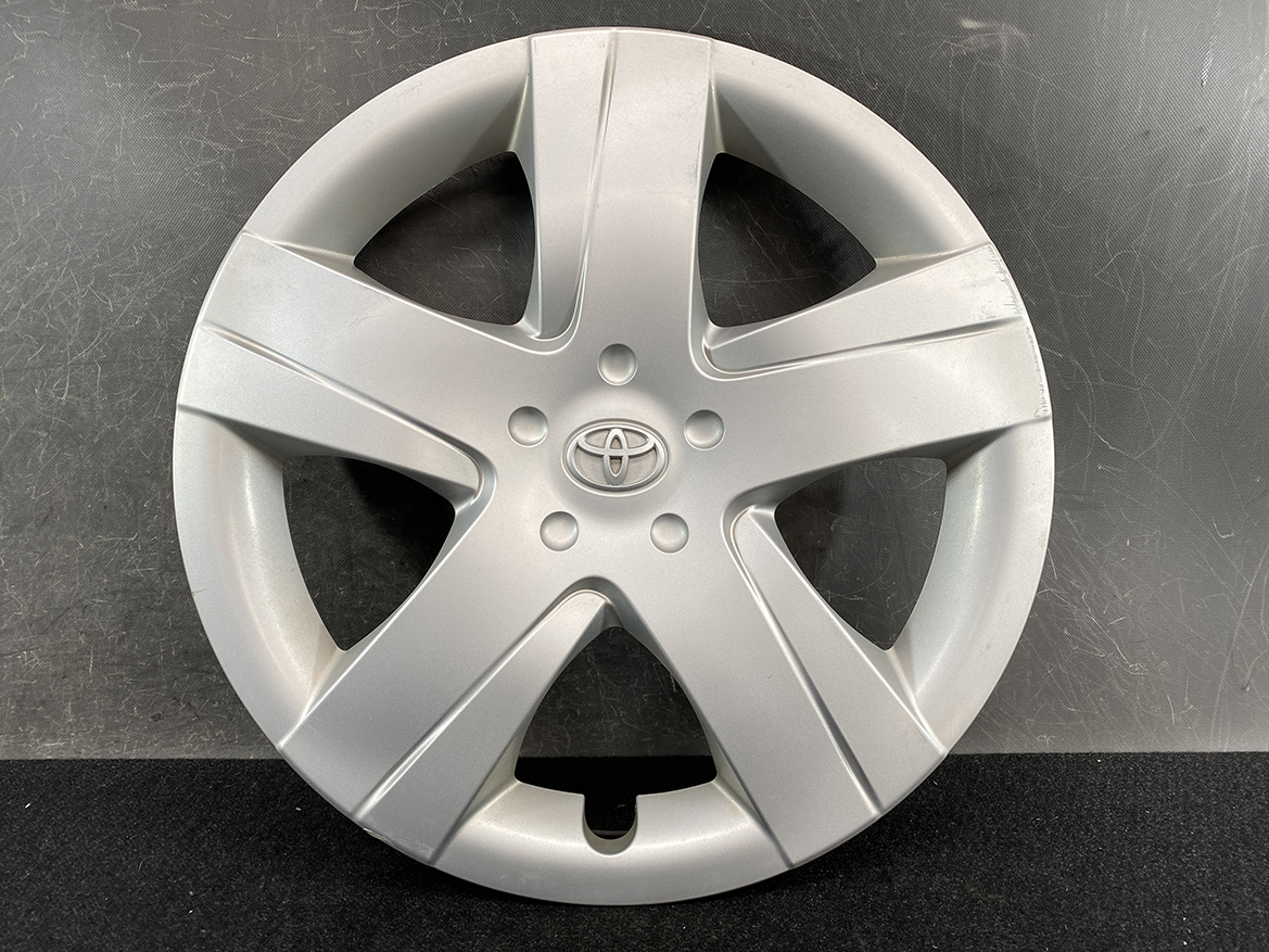 B391_2 TOYOTA RACTIS NSP120, NCP120 Genuine 16inch WHEEL CAP / HUB CAP 42602-52460 » NZ.95 » JDM-PARTS NZ » JDM-PARTS NZ Silver Toyota hubcap with five-spoke design and central emblem TOYOTA RACTIS NSP120, NCP120 Genuine 16inch WHEEL CAP / HUB CAP 42602-52460 » JDM-PARTS NZ