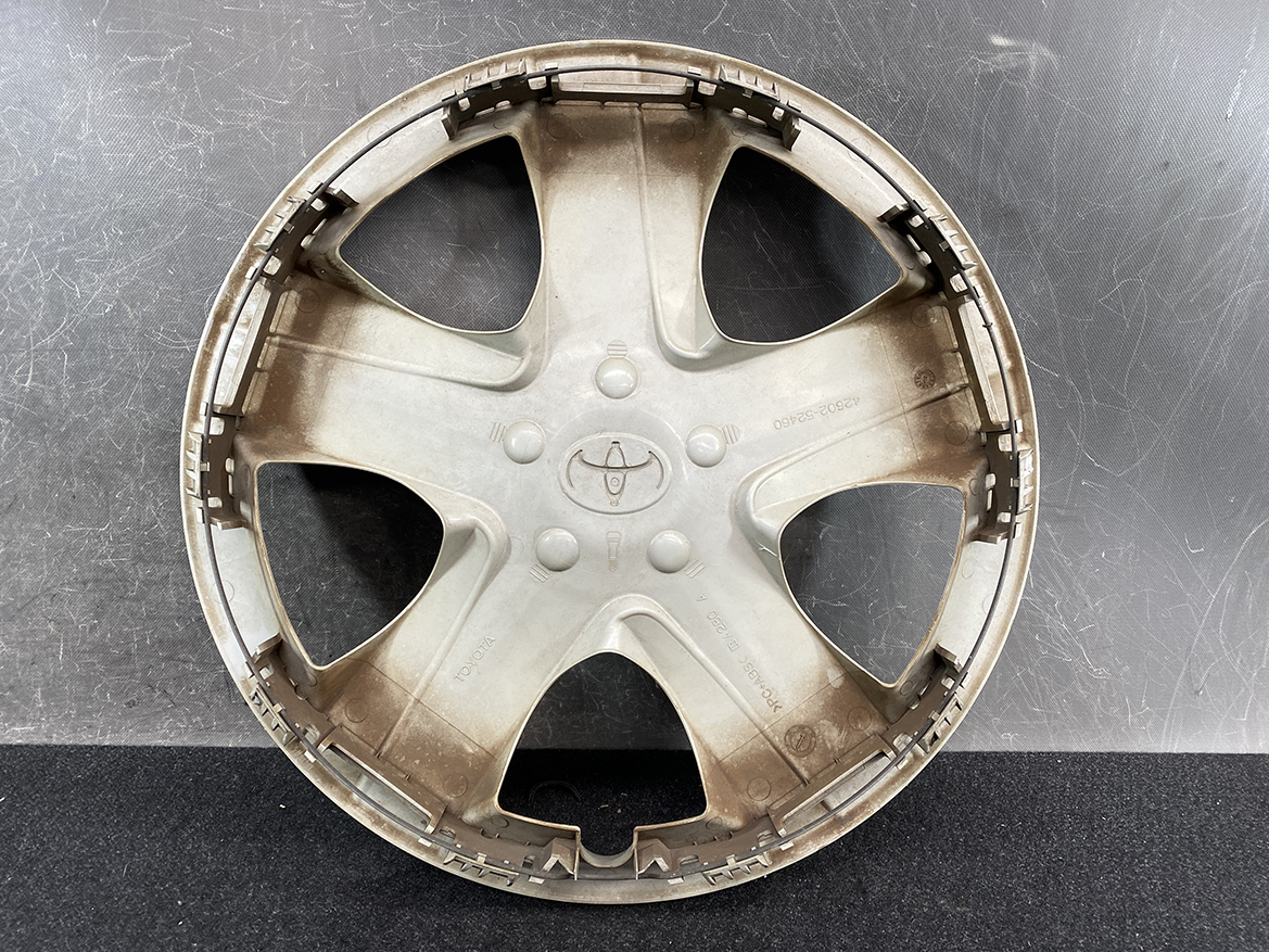 B391_3 TOYOTA RACTIS NSP120, NCP120 Genuine 16inch WHEEL CAP / HUB CAP 42602-52460 » NZ.95 » JDM-PARTS NZ » JDM-PARTS NZ Beige plastic Toyota wheel cover with five spokes and central Toyota logo, lying on a dark surface. TOYOTA RACTIS NSP120, NCP120 Genuine 16inch WHEEL CAP / HUB CAP 42602-52460 » JDM-PARTS NZ