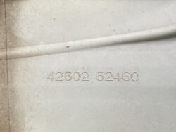 Embossed serial or part number '42602-52460' on a dusty metal surface