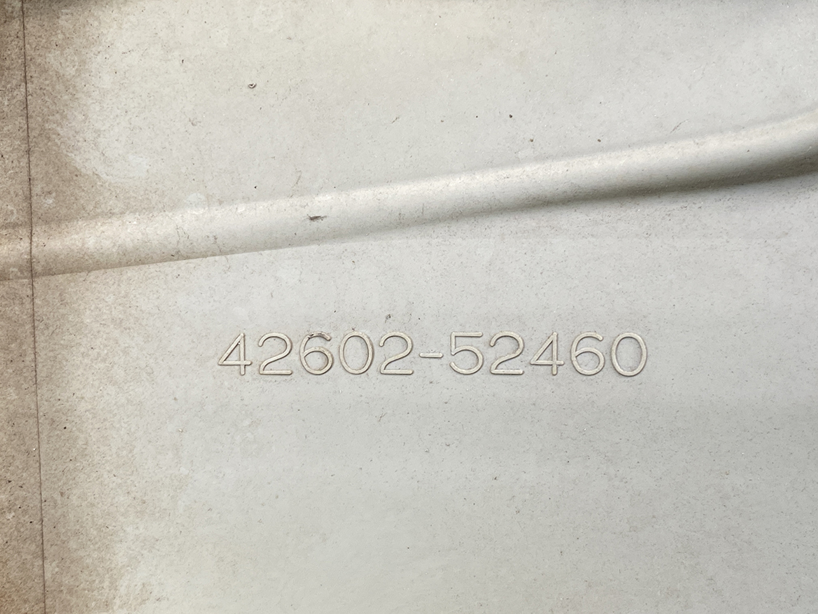 B391_4 TOYOTA RACTIS NSP120, NCP120 Genuine 16inch WHEEL CAP / HUB CAP 42602-52460 » NZ.95 » JDM-PARTS NZ » JDM-PARTS NZ Embossed serial or part number '42602-52460' on a dusty metal surface TOYOTA RACTIS NSP120, NCP120 Genuine 16inch WHEEL CAP / HUB CAP 42602-52460 » JDM-PARTS NZ