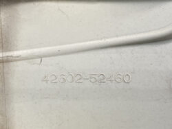Raised alphanumeric code 42602-52460 embossed on a light gray surface.