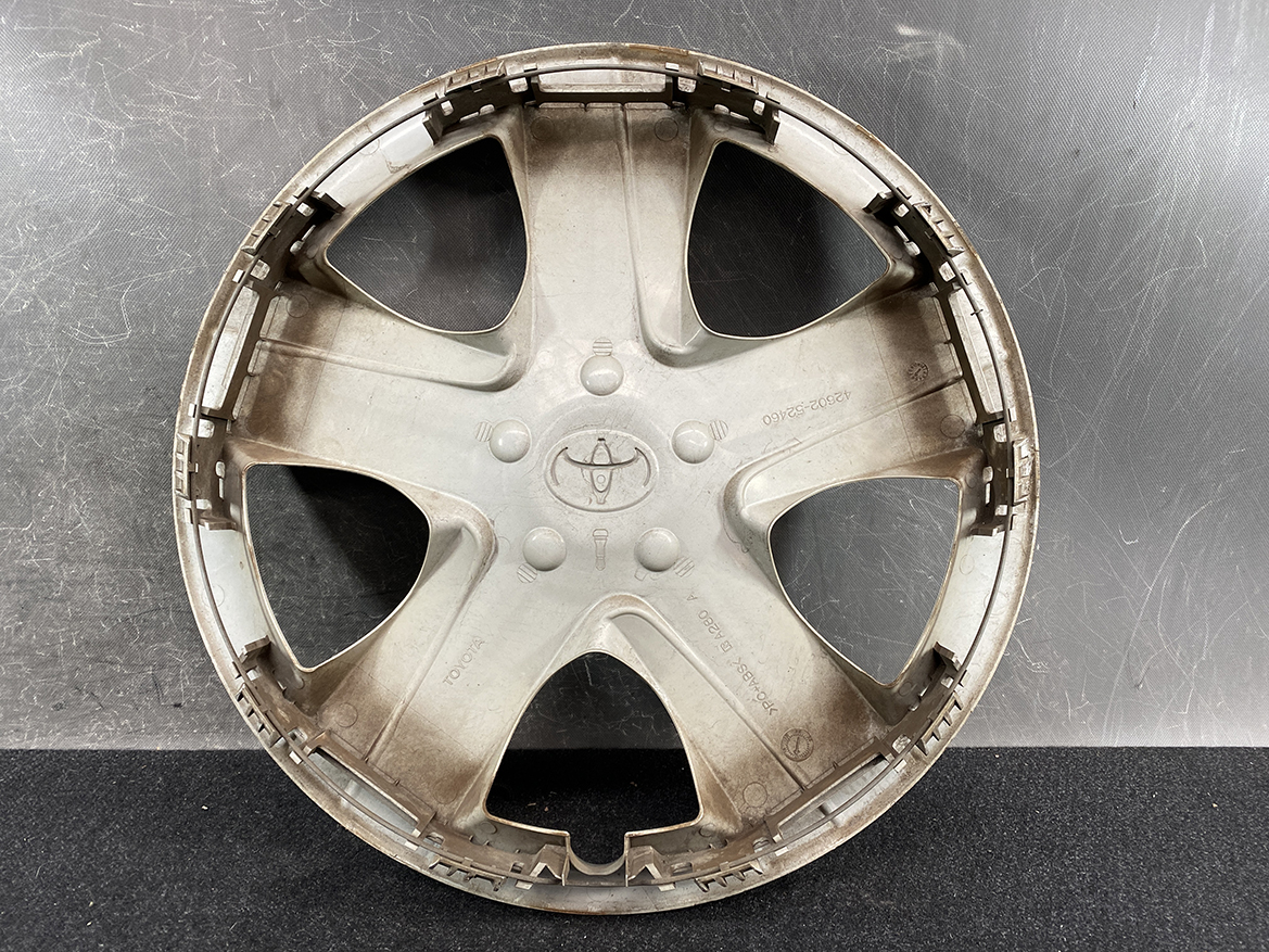 B393_3 TOYOTA RACTIS NSP120, NCP120 Genuine 16inch WHEEL CAP / HUB CAP 42602-52460 » NZ.95 » JDM-PARTS NZ » JDM-PARTS NZ Dusty gray Toyota hubcap with five-spoke design and center Toyota emblem. TOYOTA RACTIS NSP120, NCP120 Genuine 16inch WHEEL CAP / HUB CAP 42602-52460 » JDM-PARTS NZ