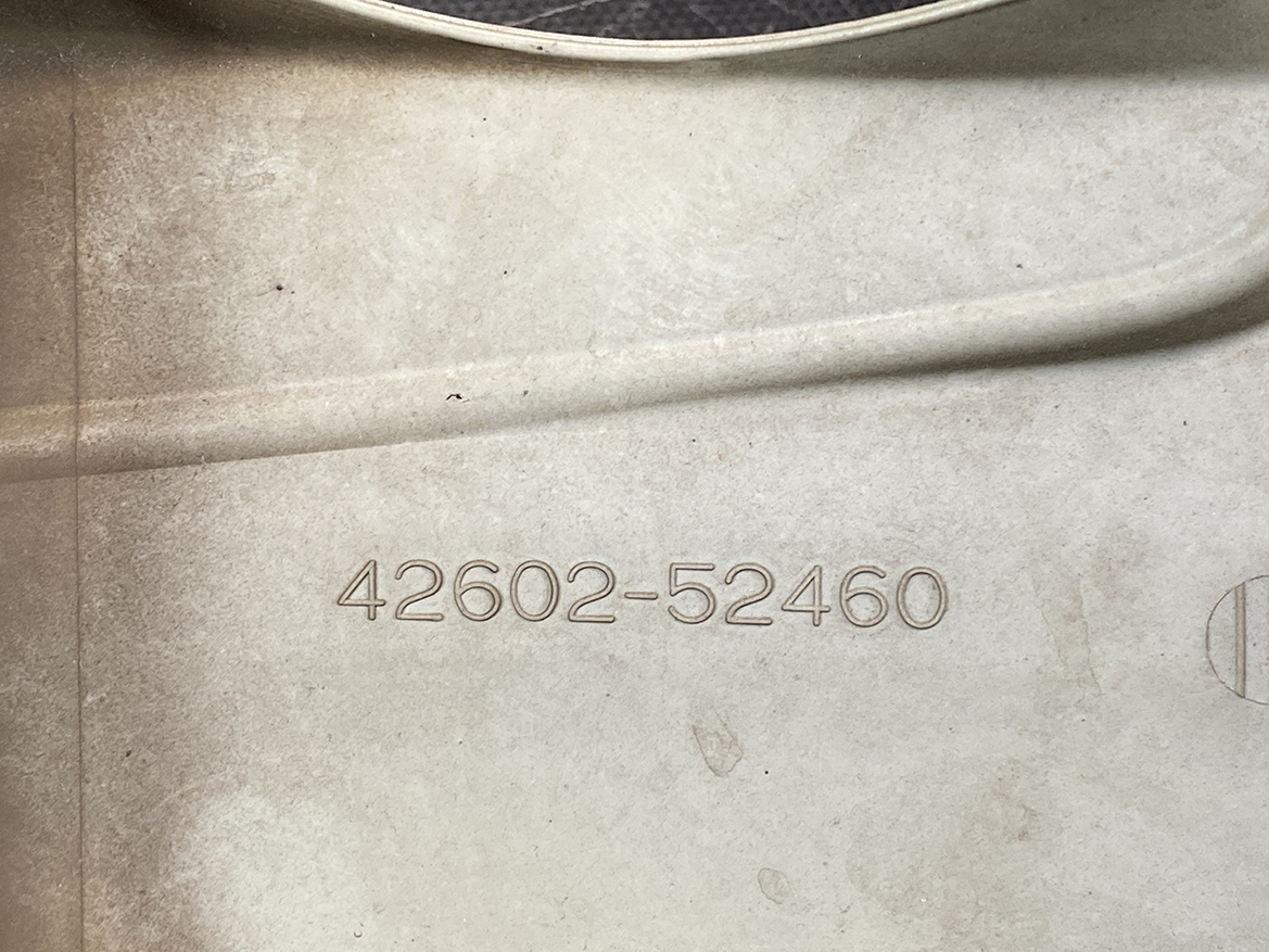 B394_4 TOYOTA RACTIS NSP120, NCP120 Genuine 16inch WHEEL CAP / HUB CAP 42602-52460 » NZ.95 » JDM-PARTS NZ » JDM-PARTS NZ Close-up of a stamped part/serial number 42602-52460 on a dusty beige surface. TOYOTA RACTIS NSP120, NCP120 Genuine 16inch WHEEL CAP / HUB CAP 42602-52460 » JDM-PARTS NZ