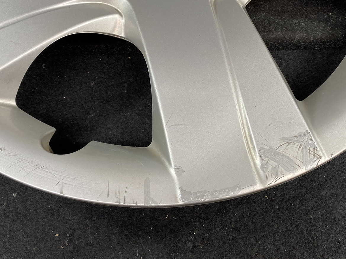 B394_6 TOYOTA RACTIS NSP120, NCP120 Genuine 16inch WHEEL CAP / HUB CAP 42602-52460 » NZ.95 » JDM-PARTS NZ » JDM-PARTS NZ Close-up of a silver alloy car wheel rim with multiple scrapes along the edge. TOYOTA RACTIS NSP120, NCP120 Genuine 16inch WHEEL CAP / HUB CAP 42602-52460 » JDM-PARTS NZ