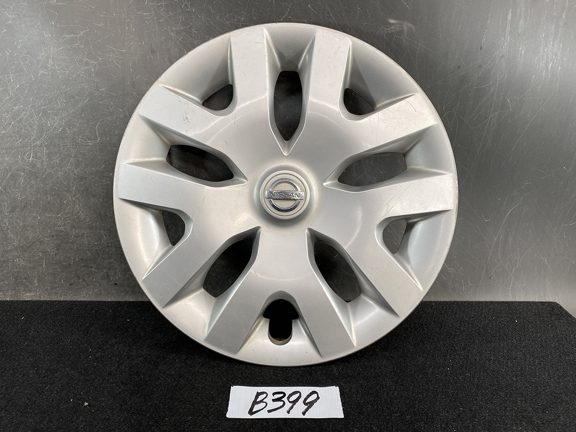 B399_1 NISSAN LEAF AZE0 Genuine 16inch WHEEL CAP / HUB CAP 40315 1KL0B x1 » NZ.95 » JDM-PARTS NZ » JDM-PARTS NZ Silver Nissan hubcap with an eight-spoke design and central Nissan emblem, resting on a dark surface. NISSAN LEAF AZE0 Genuine 16inch WHEEL CAP / HUB CAP 40315 1KL0B x1 » JDM-PARTS NZ