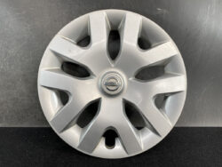 Silver Nissan hubcap with eight-spoke design and a centered Nissan emblem.