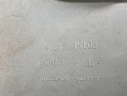 Close-up of a gray Nissan plastic part showing molded codes (40315, 1KLOB), material >PC+ABS