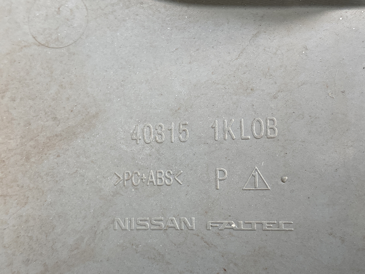 B399_4 NISSAN LEAF AZE0 Genuine 16inch WHEEL CAP / HUB CAP 40315 1KL0B x1 » NZ.95 » JDM-PARTS NZ » JDM-PARTS NZ Close-up of a gray Nissan plastic part showing molded codes (40315, 1KLOB), material >PC+ABS NISSAN LEAF AZE0 Genuine 16inch WHEEL CAP / HUB CAP 40315 1KL0B x1 » JDM-PARTS NZ