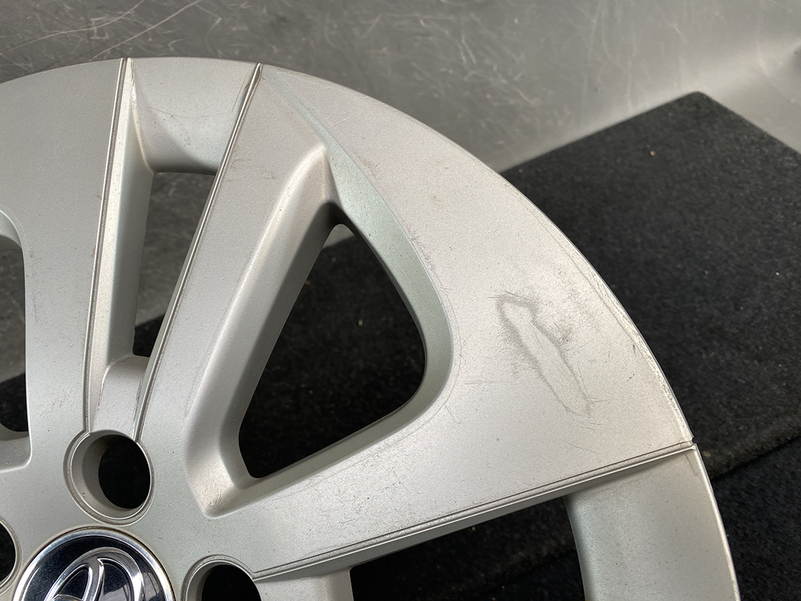 B402_6 TOYOTA PRIUS ZVW50 ZVW51 Genuine 15inch WHEEL CAP / HUB CAP » NZ.95 » JDM-PARTS NZ » JDM-PARTS NZ Silver alloy car wheel with Toyota center cap, showing surface scratches and scuff marks on the rim edge. TOYOTA PRIUS ZVW50 ZVW51 Genuine 15inch WHEEL CAP / HUB CAP » JDM-PARTS NZ