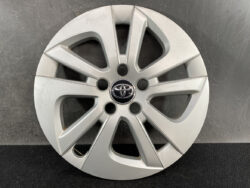 Silver Toyota hubcap with an eight-spoke alloy design and a central Toyota emblem on a dark background